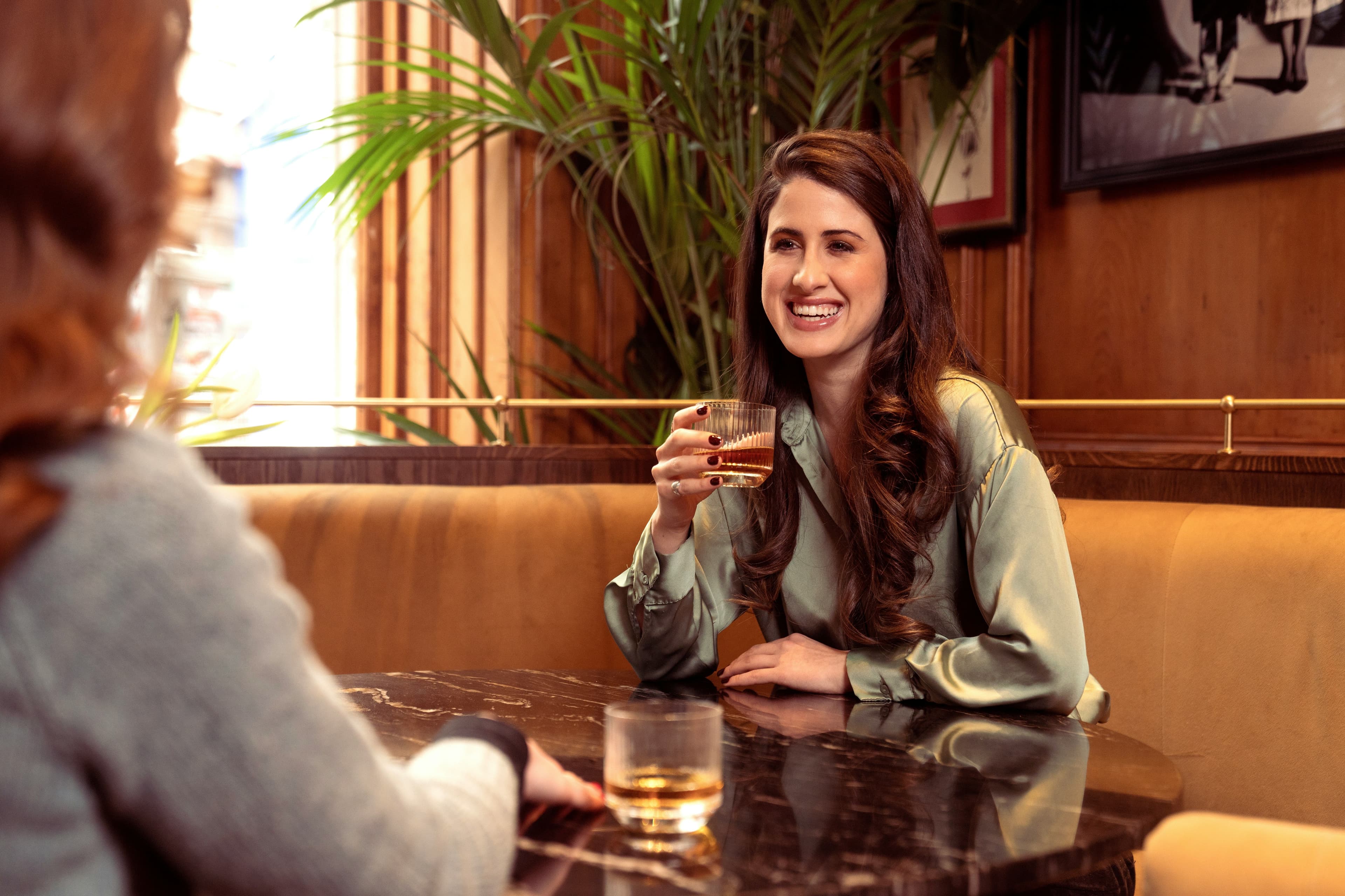 Patron sipping whisky at the bar